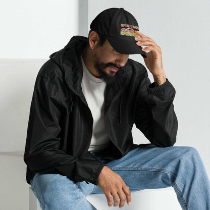 a man sitting on a white bench wearing a hat 